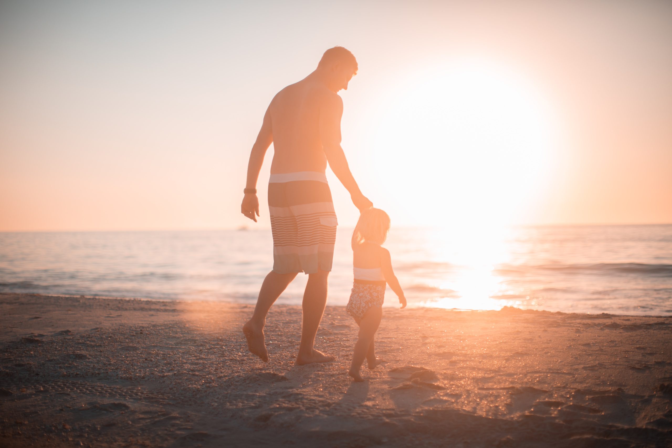 father and child at the beach